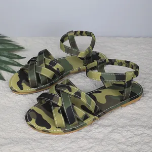 Close-up of women's camouflage flat sandals with elastic ankle straps and crisscross bands