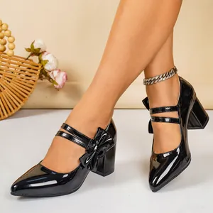 Elegant black patent leather block heel pumps with double straps and cute bow detail