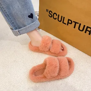 Detail view of coral pink double-strap fuzzy slippers with thick-sole and plush texture