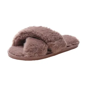 Close-up of dusty pink fuzzy cross-strap slippers for indoor home wear.