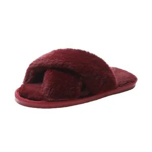 Detail view of wine red cross strap faux fur flat slippers for indoor home comfort