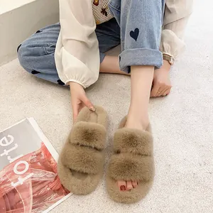Close-up view of cozy tan thick-soled fuzzy slippers being worn for home comfort