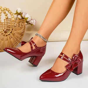Detailed view of wine red patent leather Mary Jane heels with bow and chunky heel.
