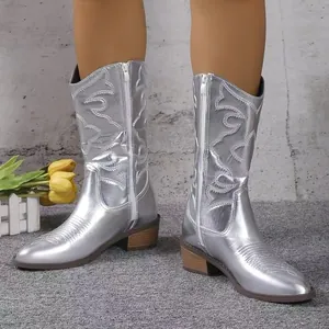 Metallic silver mid-calf cowboy boots with pointed toe and side zipper detail.