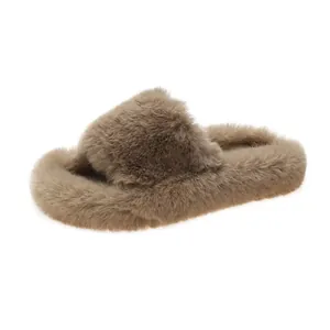 Detailed view of women's plush fuzzy platform slippers with soft faux fur texture in tan