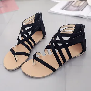 Detailed view of black strappy gladiator flat sandals with toe-ring and back zip.