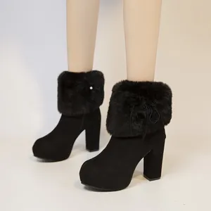 Detail view of black chunky high heel boots with plush faux fur trim and platform