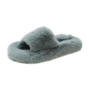 Close-up of fluffy faux fur slippers with thick soles in elegant greyish blue color