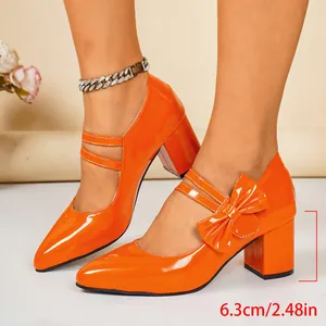 Elegant orange patent leather block heels with a stylish bow detail and 2.5-inch heel.
