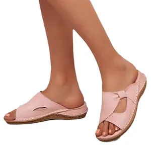 Comfortable pink wedge sandals for women featuring a vintage cutout design and open toe.
