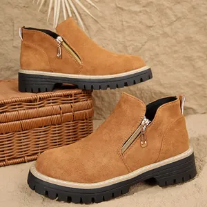 Women's brown suede ankle boots with round toe, side zipper, and chunky black rubber sole