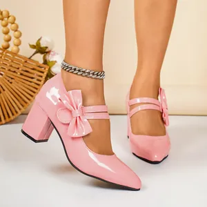Elegant pink patent leather block-heel Mary Jane shoes with a stylish bow detail.