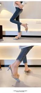 Detail of blue denim pointed-toe mules with tan rabbit fur and kitten heels