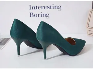 Gros plan sur des escarpins stiletto en daim vert foncé avec un bout pointu élégant