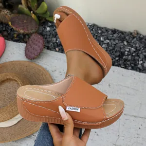 Close-up of brown platform wedge sandals with white stitching and summer vibe