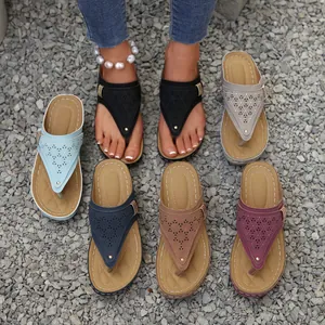 Women's hollow-out wedge thong sandals in multiple colors shown on a gravel background.