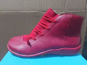 Close-up of red flat lace-up ankle boots for women with a comfortable soft sole