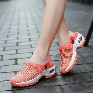 Detailed close-up view of orange breathable mesh shaker sandals for women worn on feet