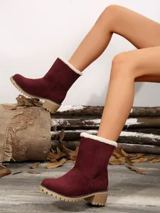 Stylish burgundy suede mid-calf winter boots with white faux fur lining worn by model.
