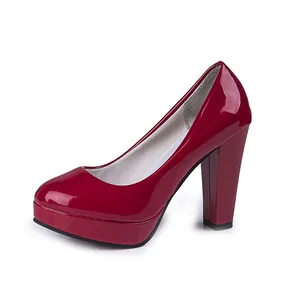 Detailed side view of glossy red patent leather platform pumps with chunky heels.