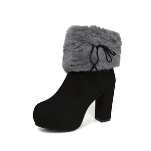 Side view detail of black chunky heel ankle boot with grey faux fur trim and bow detail