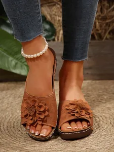 Close-up of decorative 3D leather flower on bohemian brown wedge platform sandals
