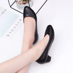 Professional black round-toe block heel pumps shoes shown on model's feet for office wear