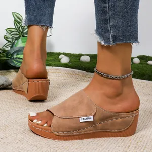 Detail view of women's peep-toe platform wedge slide sandals with white stitching