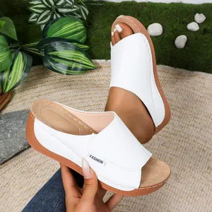 Close-up of stylish white wedge sandals with thick soles and a minimalist design