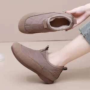 Warm fleece-lined winter snow boots for women with quilted brown patchwork design.