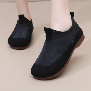 Quilted black winter boots for women with soft brown soles and warm slip-on design.