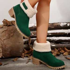 Detail view of green suede ankle boots with white shearling cuff and block heel