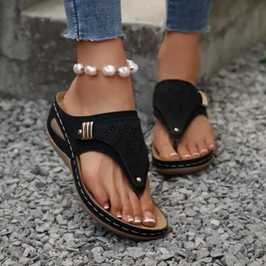Elegant black thong wedge sandals with hollow-out pattern and white stitching detail