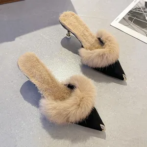 Elegant women's pointed toe kitten heel mules with luxurious fur trim and metal toe cap detail
