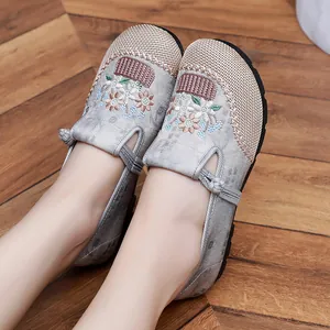 Detailed view of the intricate floral embroidery and mesh toe of these ethnic flat shoes