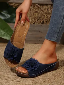 Elegant womens navy blue wedge sandals featuring a large 3D flower and open toe design