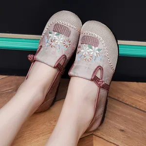 Close-up of traditional Chinese floral embroidered shoes featuring delicate woven details