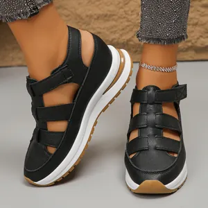 Close-up of black platform sandals featuring a breathable hollowed-out design and thick soles