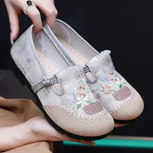 Detailed view of traditional Chinese embroidered shoes with flower patterns and soft soles