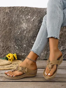 Detailed view of women's wedge thong sandals featuring stylish flower appliqués and rhinestones