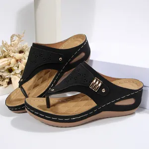 Women's black wedge flip-flop sandals with laser-cut patterns and platform soles