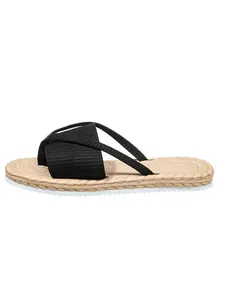 Detailed view of women's flat summer sandals with black cross straps and straw texture sole.