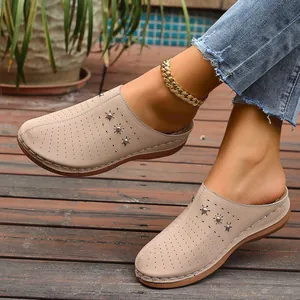 Close-up of beige breathable closed-toe platform mules for women on wooden floor