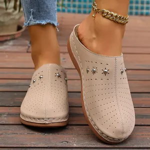 Detail showing beige closed-toe platform mules with decorative studs and sunburst cutouts
