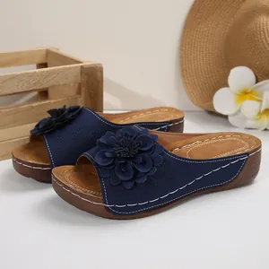 Women's summer wedge sandals with navy blue flower detail and open toe design