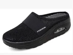 Detail of black mesh slip-on mule with air cushion sole and elastic strap.