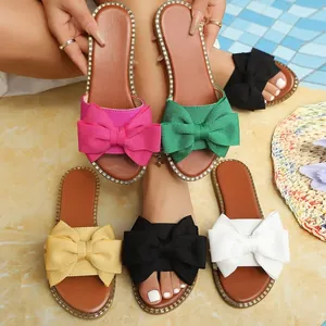 Elegant women's flat sandals with large bows and rhinestone trim in multiple colors