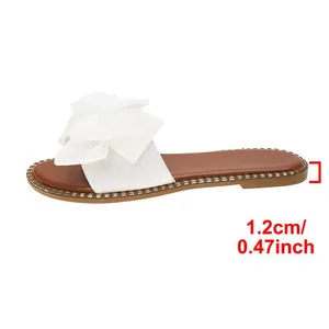 Detail view showing 1.2cm heel height of white bow flat sandals for women