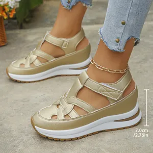 Close-up of gold wedge sandals with 7cm heel height and stylish hollow-out design