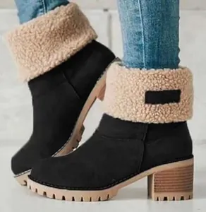 Black women's ankle snow boots with chunky block heel and beige faux shearling cuff.